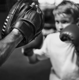 boy-boxing-training-punch-mitts-exercise-concept-PSYNPUU.jpg